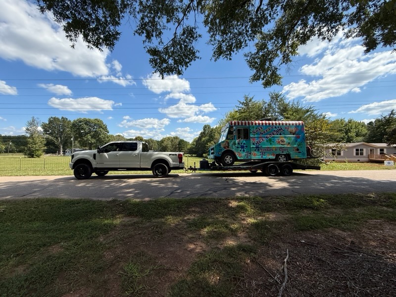 Ice cream truck on trailer in sunny outdoor setting