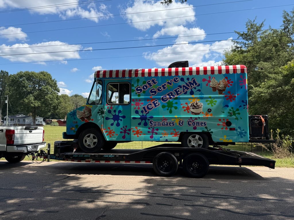 Colorful Soft Serve Ice Cream truck loaded on trailer