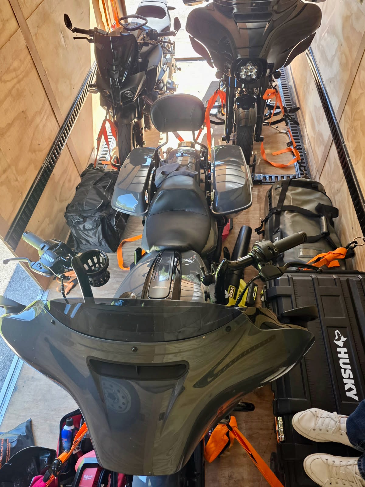 Interior view of enclosed trailer with motorcycles and equipment